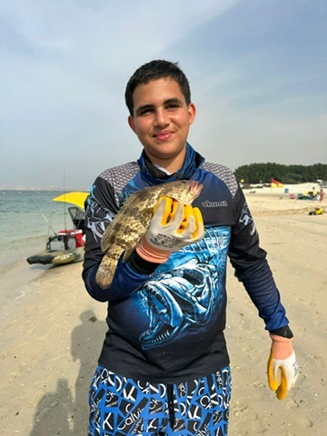 Shore angler with a grouper